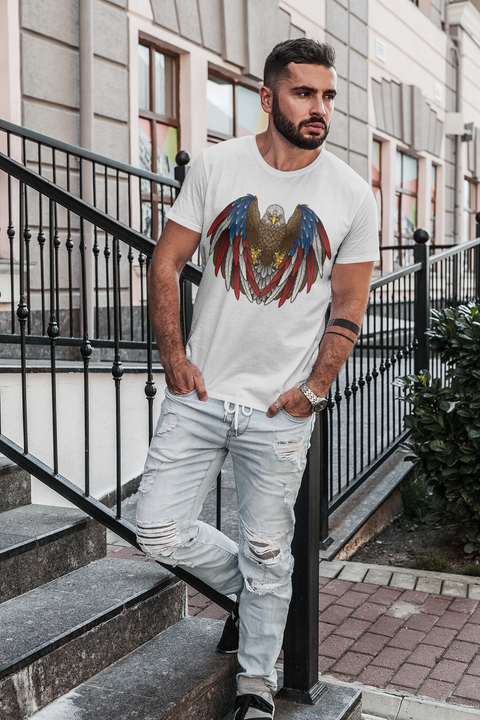 Man wearing a white shirt with an american eagle with red, white, and blue feathers spread out facing forward.